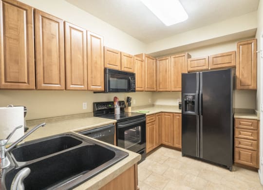 Interiors-Kitchen with side-by-side fridge at Ridge Pointe Villas townhomes