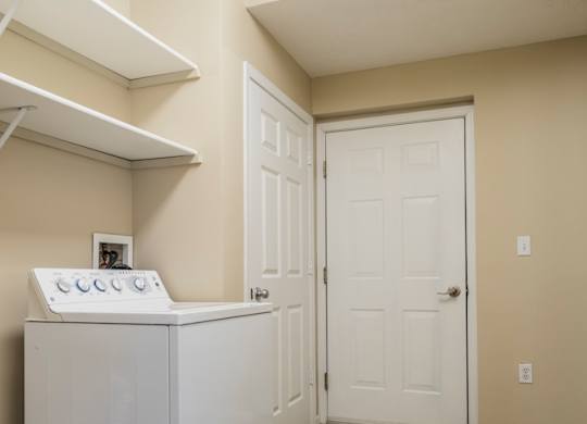 A laundry room and mud room with a full-sized washer and dryer.