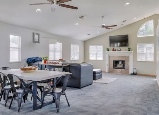 Common area with lounge area, fireplace and kitchen in the clubhouse at Skyline View apartments