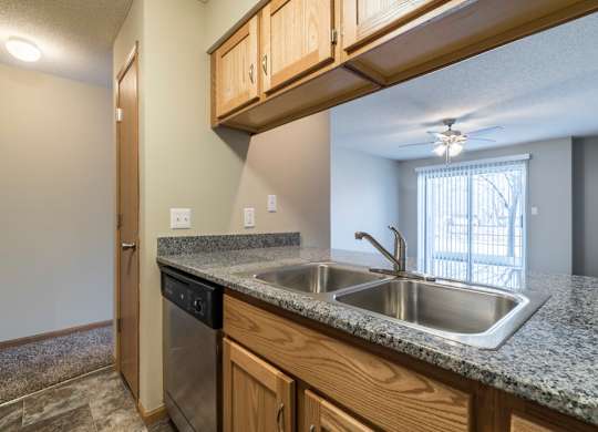 A kitchen with granite countertops and stainless steel appliances.
