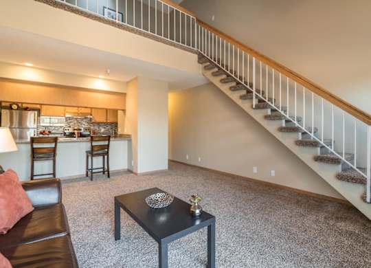 A living room with a staircase leading to the upper floor.