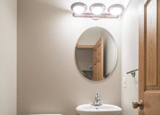 A white toilet and pedestal sink in a bathroom.