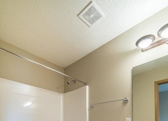 A white toilet sits next to a sink in a bathroom.