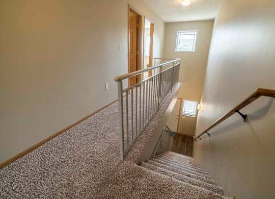 Stairwell to upstairs in a two-bedroom townhome at Southwind Villas in southwest Omaha in La Vista, NE, 68128