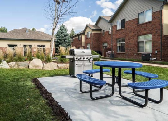 Outdoor grill with picnic table in the courtyard  at Southwind Villas in southwest Omaha in La Vista, NE, 68128