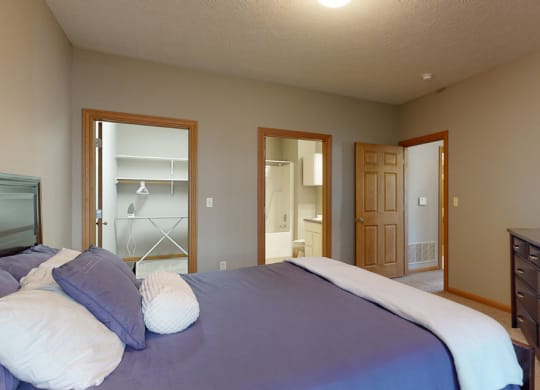 a master bedroom with walk in closet and private bath