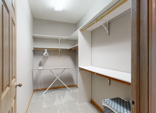 a walk in closet with ample hanging and shelving space