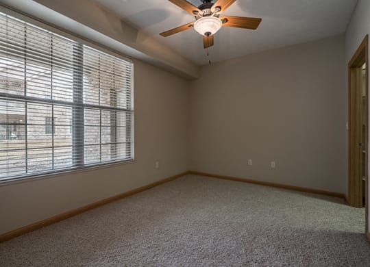 Large bedroom with ceiling fan at Stone Creek Villas Apartments in Omaha Nebraska