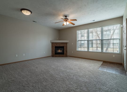 Spacious Large Living Room with Fireplace and abundant natural light at Stone Creek Villas Apartments in Omaha Nebraska