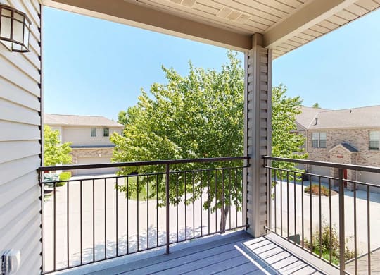 the view from the corner balcony with a tree that provides privacy