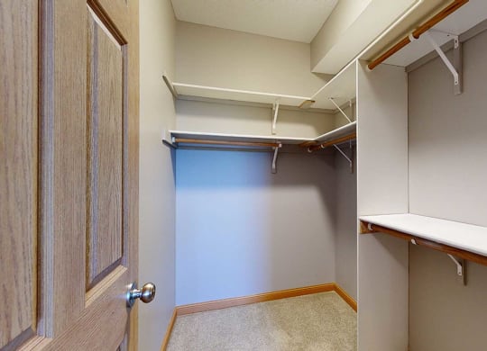 a walk in closet with built-in shelves and hanging space
