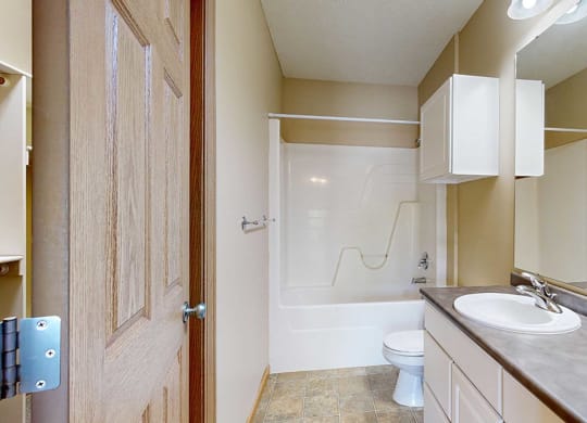 a bathroom with a toilet and a sink and a shower