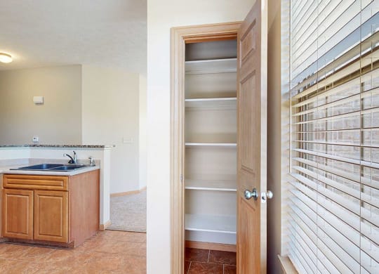 a kitchen with a pantry next to a window