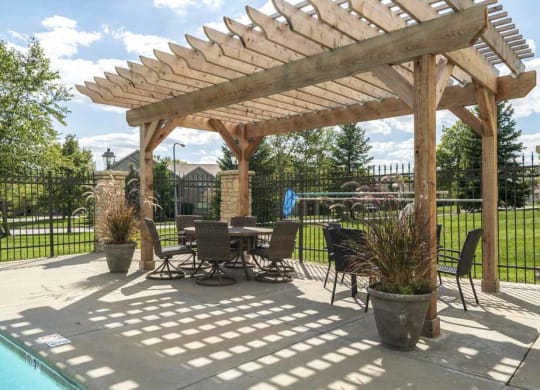 Pergola with seating next to pool at Stone Creek Villas townhomes in west Omaha NE 68116