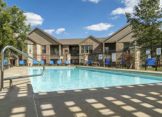 Outdoor pool with lounge seats at Stone Creek Villas townhomes in west Omaha NE 68116