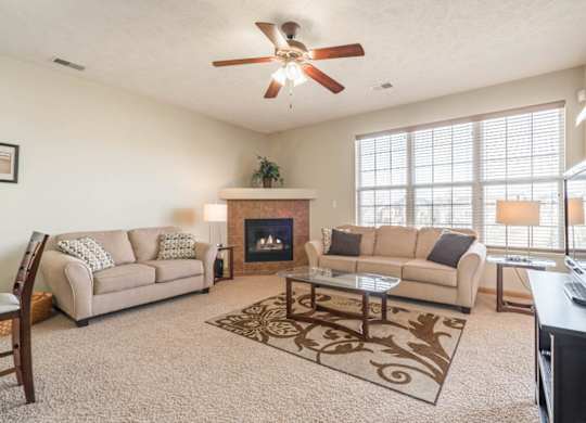 a living room with two couches and a fireplace