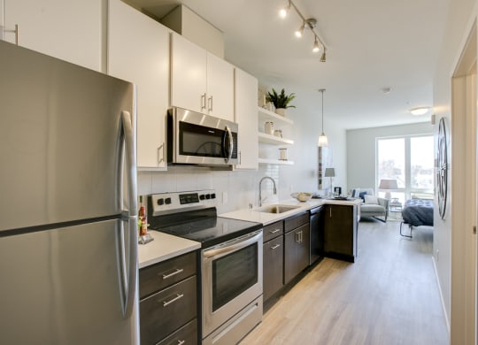 a kitchen with stainless steel appliances and white cabinets
