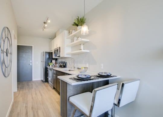 Studio kitchen with breakfast bar at The Central apartments near downtown Minneapolis MN 55408