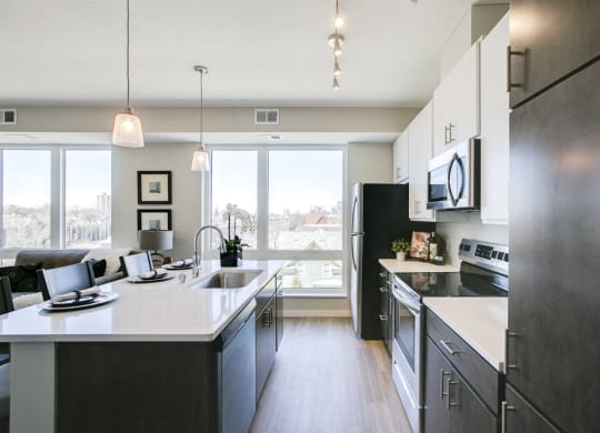 Kitchen with island and pendant lighting at The Central apartments near downtown Minneapolis MN 55408
