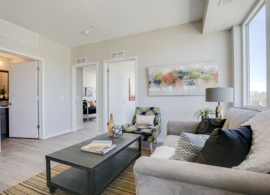 Living room with view of bathroom and bedrooms at The Central apartments near downtown Minneapolis MN 55408