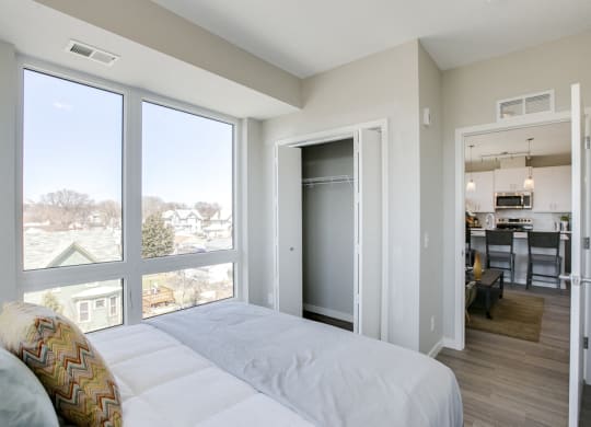 Bedroom with large windows at The Central apartments near downtown Minneapolis MN 55408