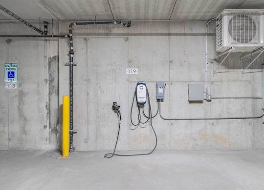 an EV charging station located in the parking garage