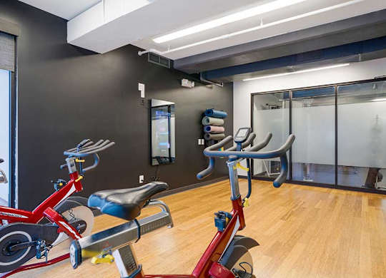 a yoga and spin studio featuring an Echelon mirror with on demand fitness courses
