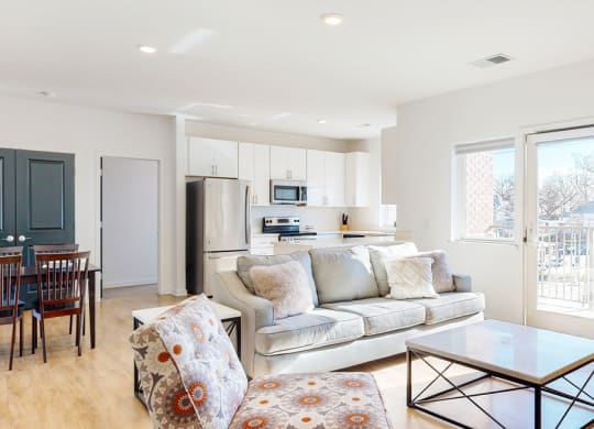 Furnished apartment living room with sofa, lounging chair, and coffee table