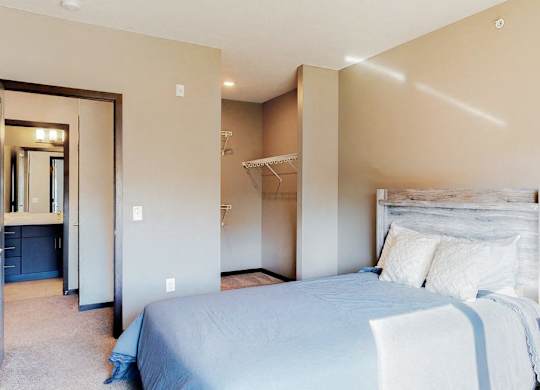 Furnished apartment bedroom with large walk in closet and easy bathroom access