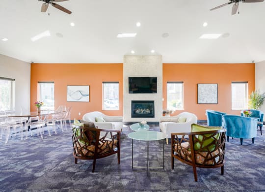 clubhouse room filled with furniture and a fire place in the back