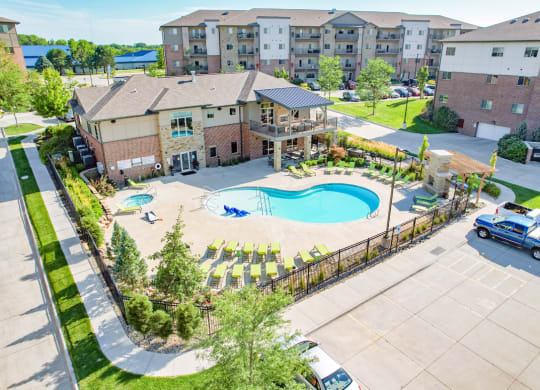ariel view of out resort style swimming pool with lounge chairs