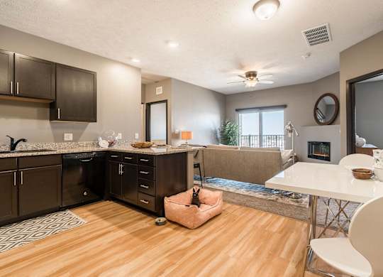 an open kitchen and living room with a fireplace and a table