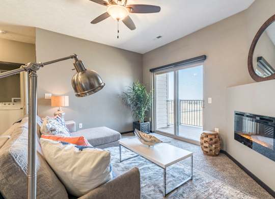 Open layout living room with fireplace at The Flats at 84 in southeast Lincoln NE 68516