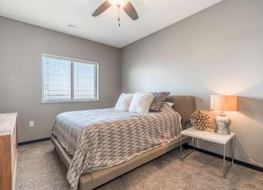 Living room with ceiling fan at The Flats at 84 in southeast Lincoln NE 68516