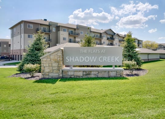 Exterior of apartment building and sign reading