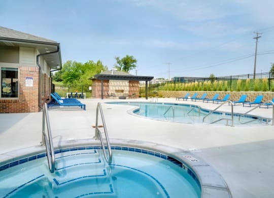Resort style pool with lounge chairs outside the clubhouse at The Flats at Shadow Creek