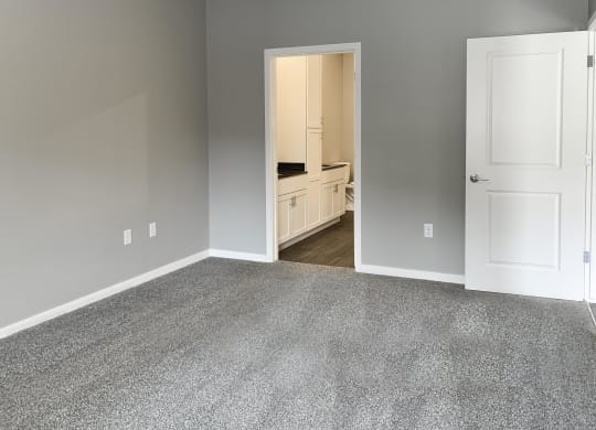 master bedroom with access to walk in closet and private bathroom The Flats at Shadow Creek in Lincoln Nebraska