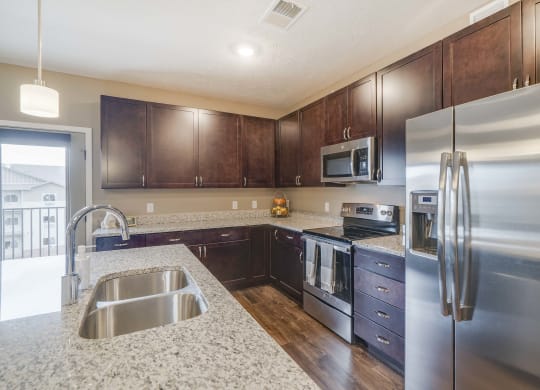 Spacious kitchens with granite countertops at The Flats at Shadow Creek new luxury apartments in east Lincoln NE 68520
