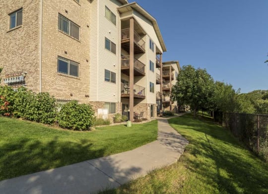 Exterior view of balconies overlooking Zorinsky Lake at Grand Legacy apartments and townhomes in west Omaha NE 68130