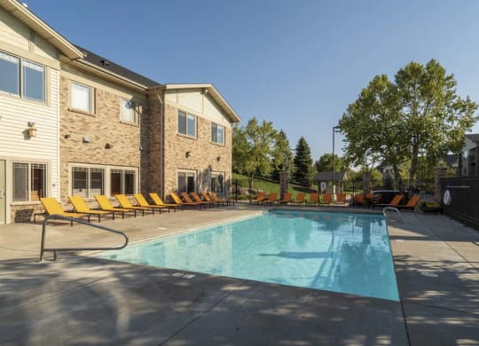 Swimming pool with seating at Grand Legacy apartments and townhomes in west Omaha NE 68130