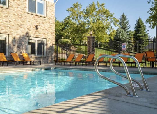 Swimming pool with poolside seating  at Grand Legacy apartments and townhomes in west Omaha NE 68130