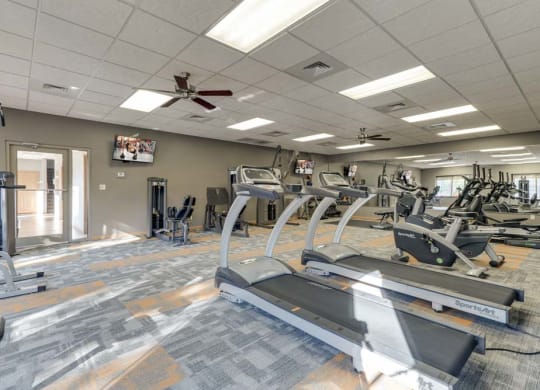 Large 24-hour fitness center with treadmills and weightlifting machines  at Grand Legacy apartments and townhomes in west Omaha NE 68130