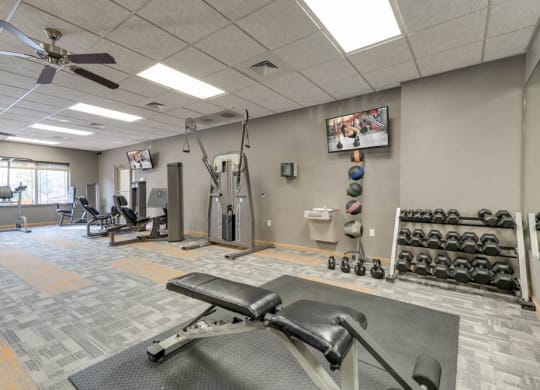 24-hour fitness center with free weights, TV and weightlifting machines  at Grand Legacy apartments and townhomes in west Omaha NE 68130