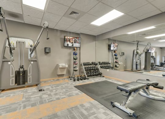 Fitness center with free weights and weightlifting equipment  at Grand Legacy apartments and townhomes in west Omaha NE 68130