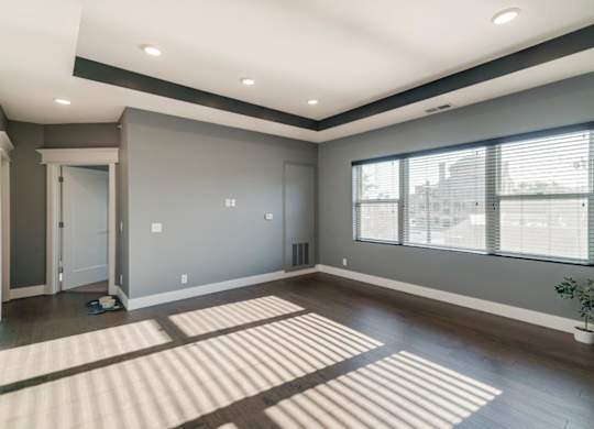 Living room with wide window and dark brown wood floors
