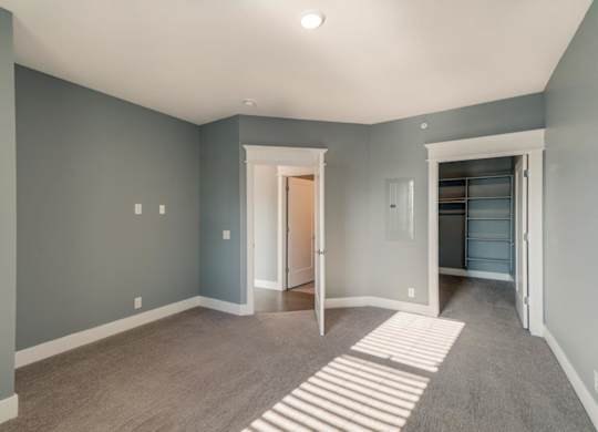 A room with a striped rug on the floor.