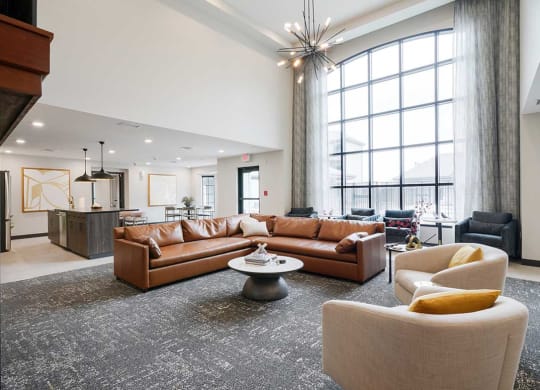 The clubhouse lounge featuring a floor to ceiling window and plenty of seating options
