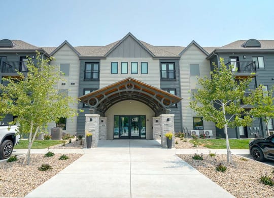 the front entrance of The Knock Apartments in Lincoln, NE with a walkway and trees