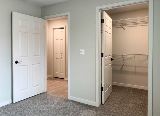 a bedroom with a closet and a door open to a closet