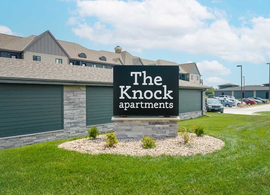 the front monument sign for The Knock Apartments in Lincoln, NE